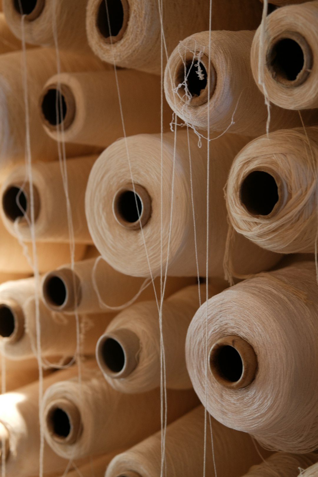 spools-of-thread-are-stacked-neatly-together-c7oxxjncv6o